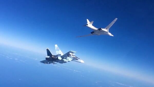 Russian Aerospace Defense Forces' Su-30SM fighter escorts a Tu-160 bomber which fired cruise missiles at Daesh targets in Syria. Still from video published by the Russian Defense Ministry. - Sputnik International