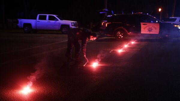 A police officer lights up flares near the scene where a shootout took place, Wednesday, Dec. 2, 2015, in San Bernardino, Calif. - Sputnik International