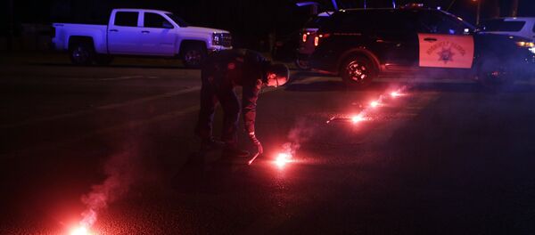 A police officer lights up flares near the scene where a shootout took place, Wednesday, Dec. 2, 2015, in San Bernardino, Calif. A police officer lights up flares near the scene where a shootout took place, Wednesday, Dec. 2, 2015, in San Bernardino, Calif. - Sputnik International