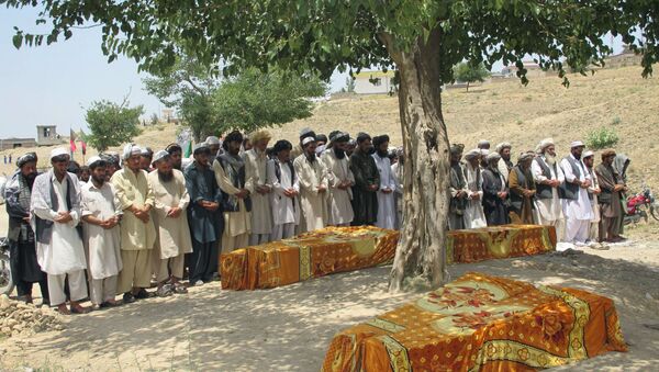 Afghans offer prayers over the covered coffins during a burial ceremony in Khost, Afghanistan. - Sputnik International