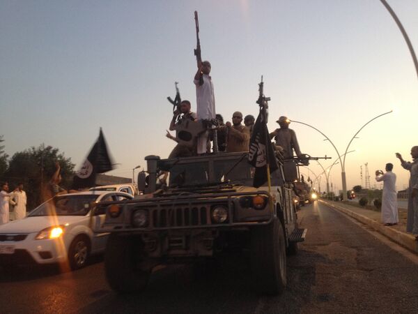 Fighters of the al-Qaida-inspired Islamic State of Iraq and the Levant (ISIL) parade in a commandeered Iraqi security forces armored vehicle down a main road at the northern city of Mosul, Iraq. (File) Fighters of the al-Qaida-inspired Islamic State of Iraq and the Levant (ISIL) parade in a commandeered Iraqi security forces armored vehicle down a main road at the northern city of Mosul, Iraq. (File) - Sputnik International