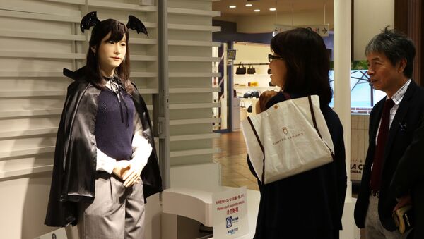 Humanoid robot Chihira Junko (L), clad in a Halloween costume, greets customers at a shopping mall in Tokyo on October 26, 2015. - Sputnik International