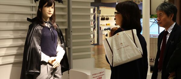 Humanoid robot Chihira Junko (L), clad in a Halloween costume, greets customers at a shopping mall in Tokyo on October 26, 2015. - Sputnik International