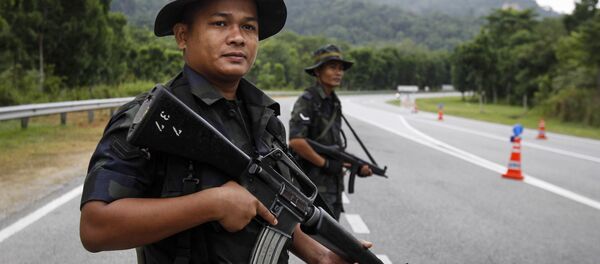 Malaysian Police stands guard at the Malaysia-Thailand border. Malaysian Police stands guard at the Malaysia-Thailand border. - Sputnik International