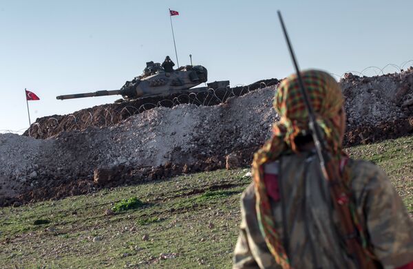 A Syrian Kurdish militia member of YPG patrols near a Turkish army tank as Turks work to build a new Ottoman tomb in the background in Esme village in Aleppo province, Syria. (File) A Syrian Kurdish militia member of YPG patrols near a Turkish army tank as Turks work to build a new Ottoman tomb in the background in Esme village in Aleppo province, Syria. (File) - Sputnik International