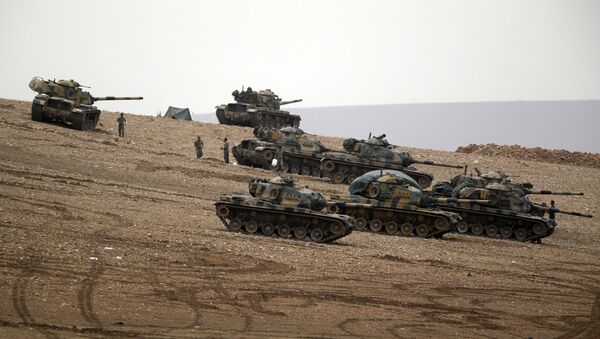 Turkish soldiers hold their positions with their tanks on a hilltop on the outskirts of Suruc, at the Turkey-Syria border . file photo - Sputnik International
