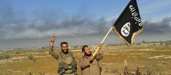 Islamic State militant waves his group's flag as he and another celebrate in Fallujah, Iraq, west of Baghdad Islamic State militant waves his group's flag as he and another celebrate in Fallujah, Iraq, west of Baghdad - Sputnik International