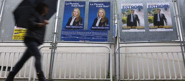 A woman walks past electoral posters of far right National Front party regional leader for southern France, Marion Marechal-Le Pen, left, and French right-wing party Les Republicains candidate Christian Estrosi, in Nice, southeastern France, Saturday, Dec. 5, 2015. A woman walks past electoral posters of far right National Front party regional leader for southern France, Marion Marechal-Le Pen, left, and French right-wing party Les Republicains candidate Christian Estrosi, in Nice, southeastern France, Saturday, Dec. 5, 2015. - Sputnik International