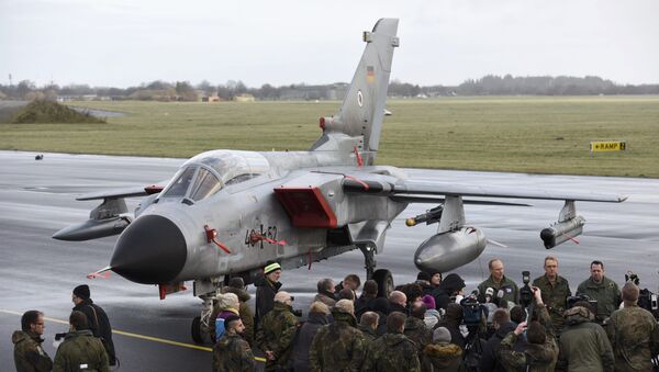 Journalists stand in front of a Tornado aircraft of the Tactical Air Force Wing 51 'Immelmann' during a presentation at German army Bundeswehr airbase in Jagel near the German-Danish border, December 4, 2015 - Sputnik International