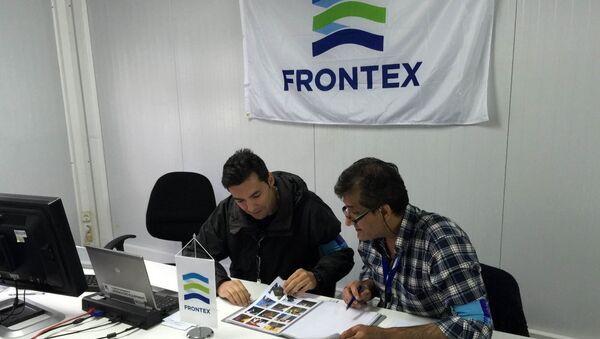 In this photo taken on Saturday, Oct. 31, 2015, Frontex officer Francisco Ramos, left, and a colleague review data at a registration center run by the EU border protection agency at Moria on the island of Lesbos in southeastern Greece. - Sputnik International