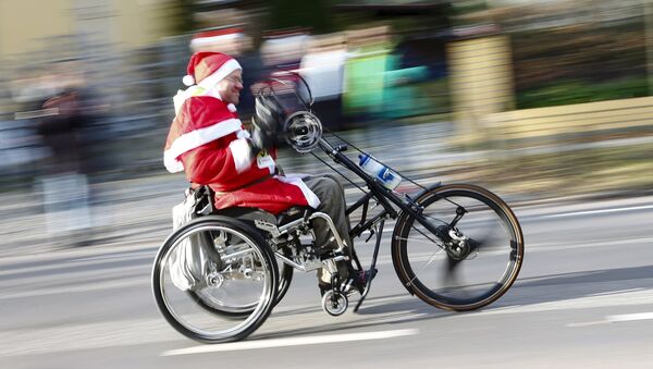 A handicapped man dressed as Father Christmas participates in the Nikolaus Lauf (Santa Claus Run) in the east German town of Michendorf, southwest of Berlin, Germany, December 6, 2015 - Sputnik International