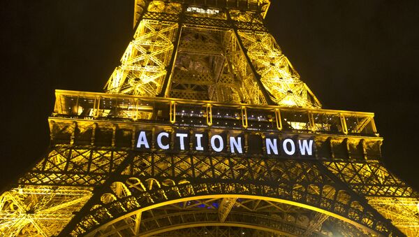 The Eiffel Tower lights up with the sloganAction Nowreferring to the COP21, United Nations Climate Change Conference in Paris, Sunday, Dec. 6, 2015 - Sputnik International