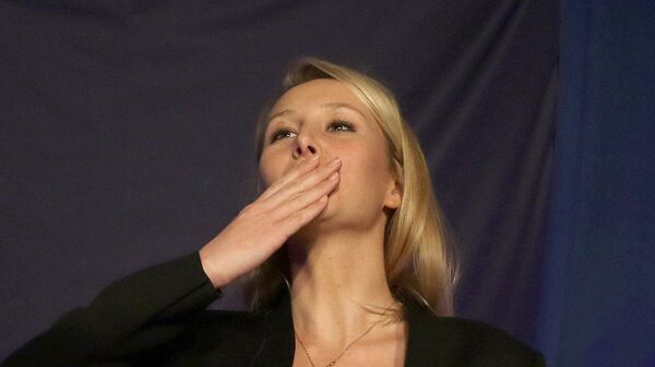 Far right National Front party regional leader for southeastern France, Marion Marechal-Le Pen blows a kiss to supporters , at a meeting with supporters, after the first round of the regional elections, in Carpentras, southern France, Sunday, Dec. 6, 2015. - Sputnik International
