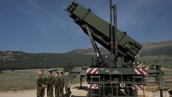 German soldiers stand to attention in front of a German Patriot missile launcher at the Gazi barracks in Kahramanmaras, southern Turkey on March 25, 2014 - Sputnik International