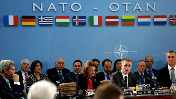Montenegro's Foreign Minister Igor Luksic (at table, 2nd R) delivers remarks with Defense Minister Milica Pejanovic (3rd R) after Montenegro was welcomed as a new member at the NATO ministerial meetings at the NATO headquarters in Brussels December 2, 2015 - Sputnik International