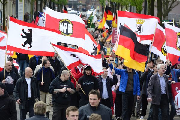 Supporters of Germany's right extremist National Democratic Party (NPD) wave flags as they take part in a Neo-Nazi demonstration in Berlin.  - Sputnik International