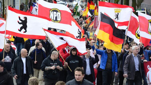 Supporters of Germany's right extremist National Democratic Party (NPD) wave flags as they take part in a Neo-Nazi demonstration in Berlin. - Sputnik International