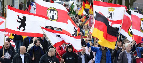 Supporters of Germany's right extremist National Democratic Party (NPD) wave flags as they take part in a neonazi demonstration in Berlin. (File) Supporters of Germany's right extremist National Democratic Party (NPD) wave flags as they take part in a neonazi demonstration in Berlin. (File) - Sputnik International