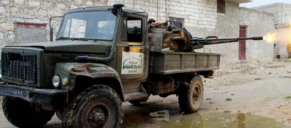 An opposition fighter from the Ahrar al-Sham Brigade, part of the Islamic front coalition, fires a machine gun during clashes with government forces as he defends the Marjah neighbourhood of the northern Syrian city of Aleppo on January 27, 2014 - Sputnik International