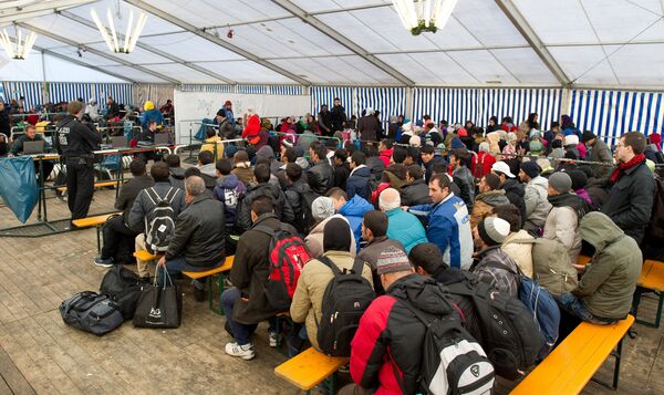 Refugees wait to be registered in a service tent at the train station in the Bavarian city of Passau, southern Germany, Monday, Nov. 2, 2015.  - Sputnik International