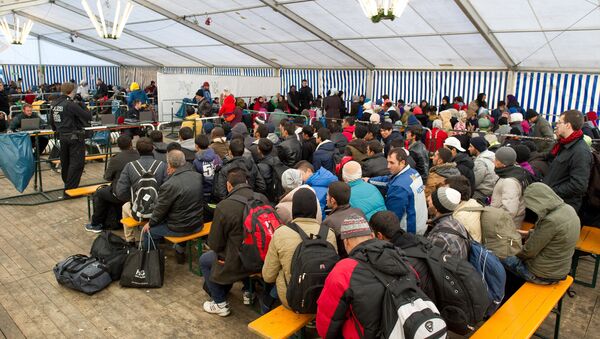 Refugees wait to be registered in a service tent at the train station in the Bavarian city of Passau, southern Germany, Monday, Nov. 2, 2015. - Sputnik International