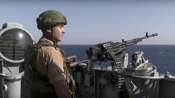 In this photo made from the footage taken from Russian Defense Ministry official web site on Friday, Nov. 27, 2015, a Russian seaman stands next to a machine gun on the Russian missile cruiser Moskva, near the shore of Syria’s province of Latakia, Syria - Sputnik International