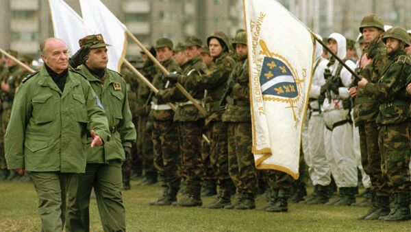 Bosnian President Alija Izetbegovic reviews troops during a military parade of the Bosnian Army in Zenica, 100 kilometres (62 miles) north of Sarajevo, Sunday December 10, 1995. Izetbegovic said that the Bosnian Army should be ready if something goes wrong during or after the NATO mandate to police the Dayton accord. At right is Bosnian Army Gen. Sakib Mahmuljin - Sputnik International