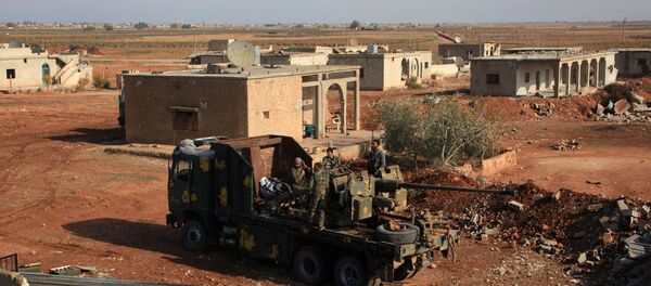 Syrian government troops stand on a vehicle carrying heavy artillery  in the village of Akoula near the airport of Kweyris, in the northern Syrian province of Aleppo, after they re-took the area from the control of the Islamic State (IS) group (File) - Sputnik International