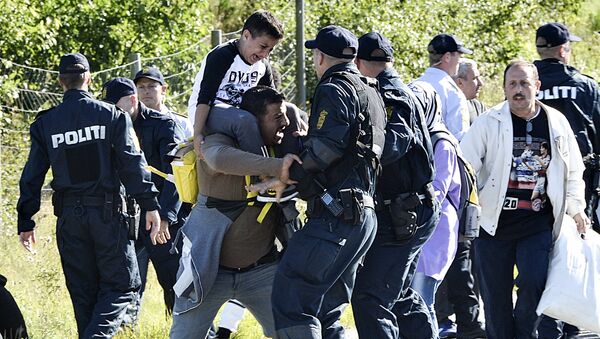 Danish police clash with one of around 300 migrants who were walking north on a highway in southern Denmark . file photo - Sputnik International