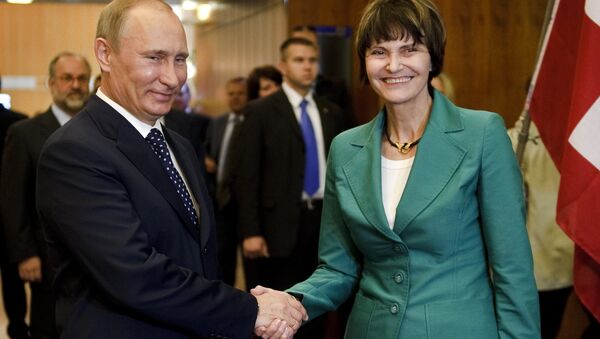 Russian Prime Minister Vladimir Putin (L) shakes hands to Swiss President Micheline Calmy-Rey prior to bilateral talks on the sideline of the 100th annual conference of the International Labor Organization (ILO) at the United Nations Offices on June 15, 2011 in Geneva - Sputnik International