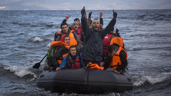Migrants and refugees react as they arrive on a dinghy from the Turkish coast to the northeastern Greek island of Lesbos on Wednesday, Dec. 9, 2015. - Sputnik International