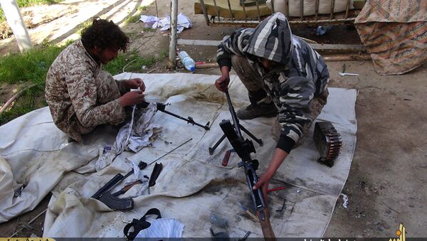 In this file photo released on June 16, 2015, by Ismamic State militant group supporters on an anonymous photo sharing website, Islamic State militants clean their weapons in Deir el-Zour city, Syria - Sputnik International