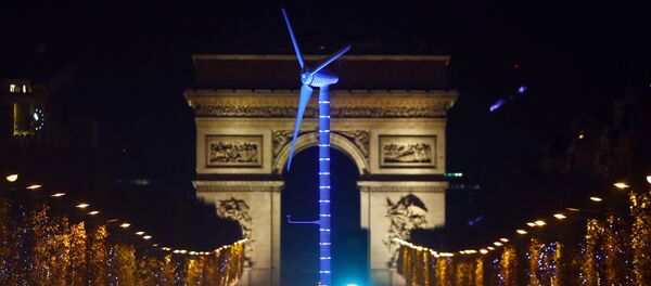 A power-generating windmill turbine is seen on the Champs Elysees avenue with the Arc de Triomphe in background as part of the COP21, United Nations Climate Change Conference, in Paris, Wednesday, Dec. 2, 2015 - Sputnik International