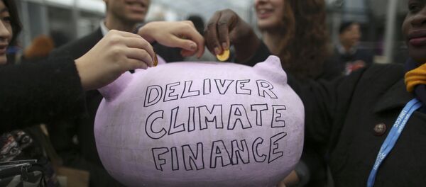 Participants contribute coins into a piggy bank during the World Climate Change Conference 2015 (COP21) at Le Bourget, near Paris, France, December 10, 2015 Participants contribute coins into a piggy bank during the World Climate Change Conference 2015 (COP21) at Le Bourget, near Paris, France, December 10, 2015 - Sputnik International