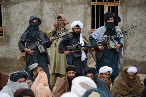 In this Tuesday, Nov. 3, 2015 photo, Afghan Taliban fighters listen to Mullah Mohammed Rasool, unseen, the newly-elected leader of a breakaway faction of the Taliban, in Farah province, Afghanistan In this Tuesday, Nov. 3, 2015 photo, Afghan Taliban fighters listen to Mullah Mohammed Rasool, unseen, the newly-elected leader of a breakaway faction of the Taliban, in Farah province, Afghanistan - Sputnik International