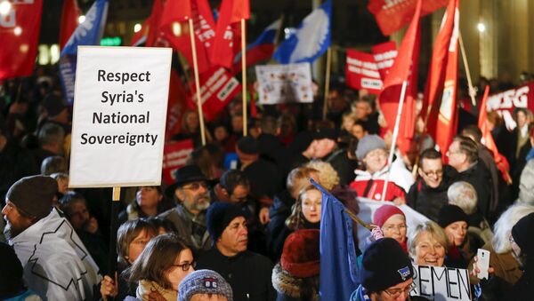 People protest in front of Brandenburg gate in Berlin, Germany, December 3, 2015, with a poster Respect Syria's National Sovereignity against the possible deployment of German aircraft to Syria - Sputnik International