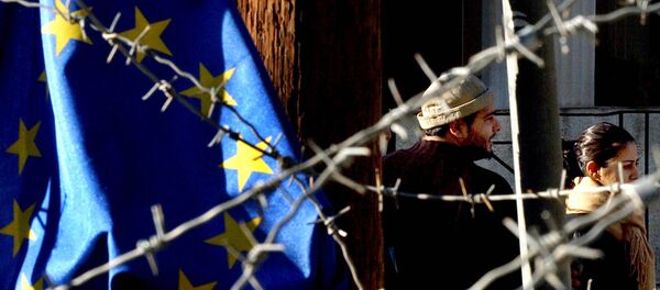 Turkish Cypriot couple, seen behind barbed wire and an EU flag, as they cross the Ledra Palace checkpoint in Nicosia, Cyprus (File) Turkish Cypriot couple, seen behind barbed wire and an EU flag, as they cross the Ledra Palace checkpoint in Nicosia, Cyprus (File) - Sputnik International