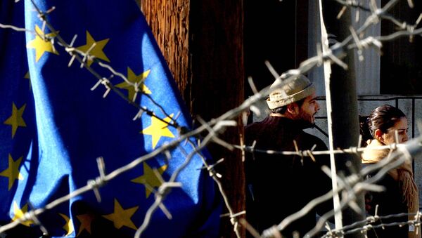 Turkish Cypriot couple, seen behind barbed wire and an EU flag, as they cross the Ledra Palace checkpoint in Nicosia, Cyprus (File) - Sputnik International