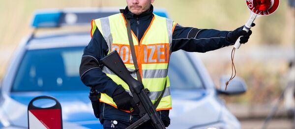 A policeman stops cars on highway 44 at a checkpoint in the Aachen, Germany A policeman stops cars on highway 44 at a checkpoint in the Aachen, Germany - Sputnik International