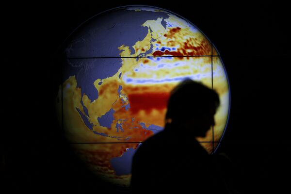 A woman walks past a map showing the elevation of the sea in the last 22 years during the World Climate Change Conference 2015 (COP21) at Le Bourget, near Paris, France, December 11, 2015 A woman walks past a map showing the elevation of the sea in the last 22 years during the World Climate Change Conference 2015 (COP21) at Le Bourget, near Paris, France, December 11, 2015 - Sputnik International