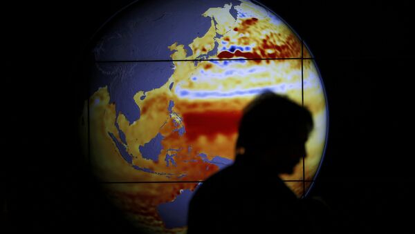 A woman walks past a map showing the elevation of the sea in the last 22 years during the World Climate Change Conference 2015 (COP21) at Le Bourget, near Paris, France, December 11, 2015 - Sputnik International