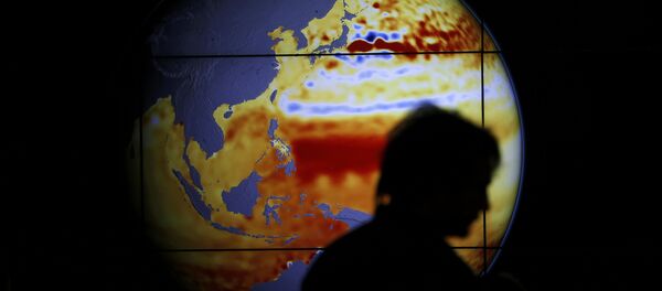 A woman walks past a map showing the elevation of the sea in the last 22 years during the World Climate Change Conference 2015 (COP21) at Le Bourget, near Paris, France, December 11, 2015 - Sputnik International