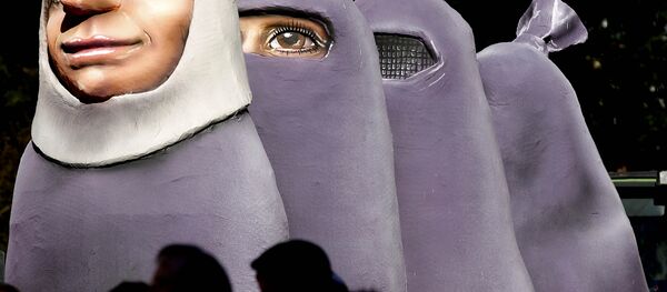 A carnival float depicting women wearing a burka is one part of the traditional carnival Rosemonday Parade in Duesseldorf, Germany, Monday, March 7, 2011. A carnival float depicting women wearing a burka is one part of the traditional carnival Rosemonday Parade in Duesseldorf, Germany, Monday, March 7, 2011. - Sputnik International