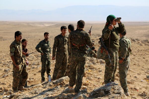 A group of coalition forces, which includes People's Protection Units (YPG) Women's Protection Units (YPJ), Sutoro militia, a pro-government Syriac Christian movement, and other forces, monitor the area in al-Hol in the Syrian Hasakeh province, some 650 kms northeast of Damascus, near the Iraqi border on November 2, 2015 A group of coalition forces, which includes People's Protection Units (YPG) Women's Protection Units (YPJ), Sutoro militia, a pro-government Syriac Christian movement, and other forces, monitor the area in al-Hol in the Syrian Hasakeh province, some 650 kms northeast of Damascus, near the Iraqi border on November 2, 2015 - Sputnik International