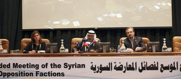 In this Thursday, Dec, 10, 2015 photo Abdulaziz bin Saqr, center, Chairman of the Gulf Research Council, speaks as Louay Safi, right, spokesperson for the Syrian National Coalition, and Hind Kabawat, left, a member of the elected committee that will negotiate with the Syrian regime, listen during a press conference after a three-day meeting of Syrian opposition groups in Riyadh, Saudi Arabia - Sputnik International