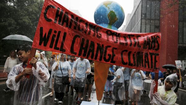 Indigenous boys hold a banner during a rally held the day before the start of the Paris Climate Change Conference (COP21), in Sao Paulo, Brazil, November 29, 2015 - Sputnik International