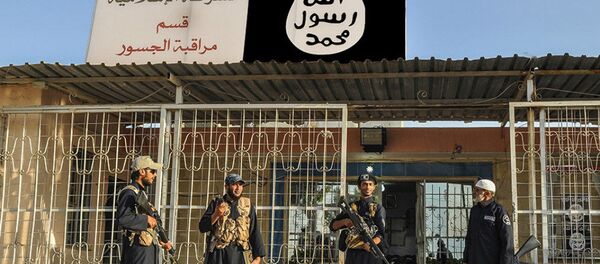 19, 2014, file photo, which has been verified and is consistent with other AP reporting, shows Islamic State group policemen standing guard in front of a police station in Nineveh province, Iraq - Sputnik International