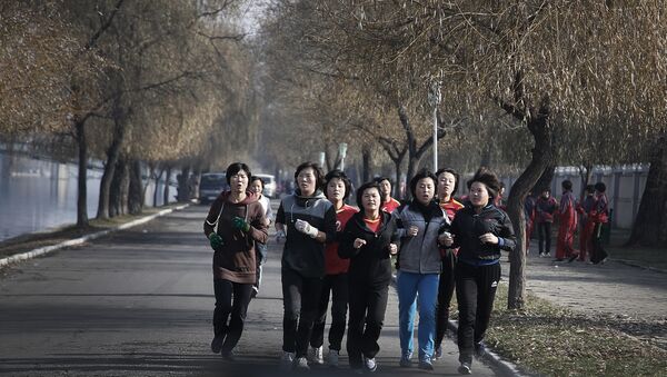 North Korean ladies jog along the Pothong River on Tuesday, Dec. 1, 2015, in Pyongyang, North Korea - Sputnik International