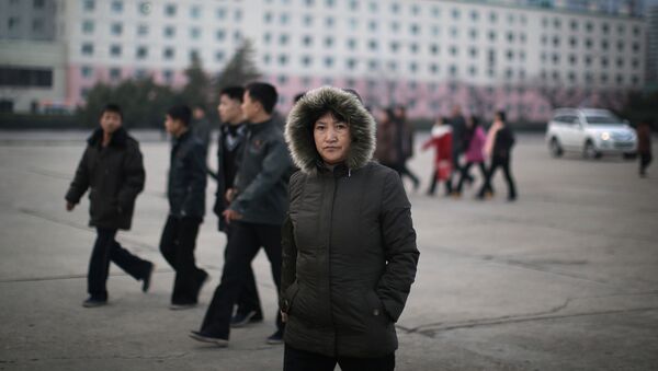 A North Korean woman walks down the streets of Pyongyang, North Korea on Tuesday, Dec. 1, 2015 where the winter season has started - Sputnik International