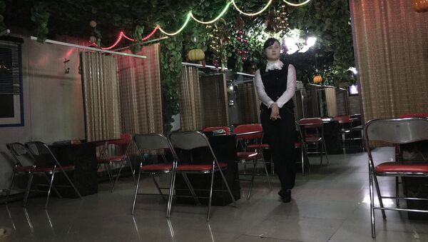 In this Monday, Nov. 30, 2015, photo, a waitress waits to serve customers in a Korean BBQ restaurant in Pyongyang, North Korea - Sputnik International